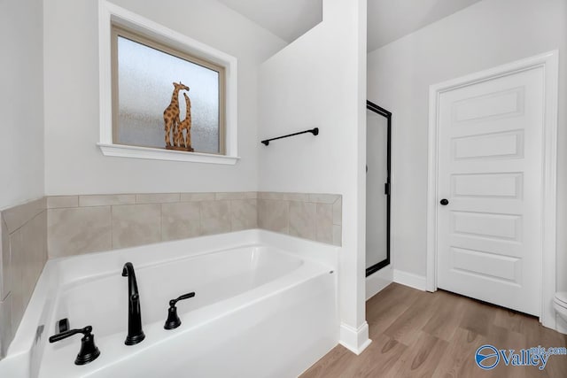 bathroom featuring hardwood / wood-style floors and a washtub