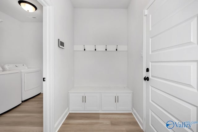 mudroom with washing machine and dryer and light hardwood / wood-style flooring