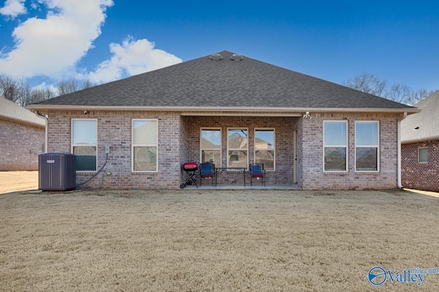 back of house with a patio area, central air condition unit, and a yard