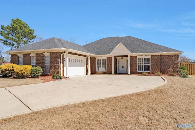 ranch-style home with a garage, fence, brick siding, and roof with shingles