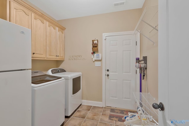 washroom featuring tile patterned floors, visible vents, cabinet space, separate washer and dryer, and baseboards