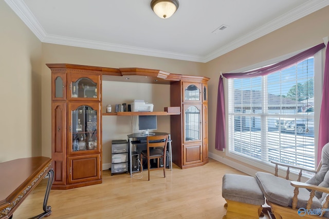 office featuring a wealth of natural light, light wood finished floors, and ornamental molding