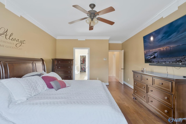 bedroom featuring ceiling fan, baseboards, dark wood-style floors, and crown molding