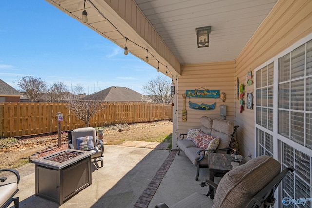 view of patio with an outdoor fire pit and fence