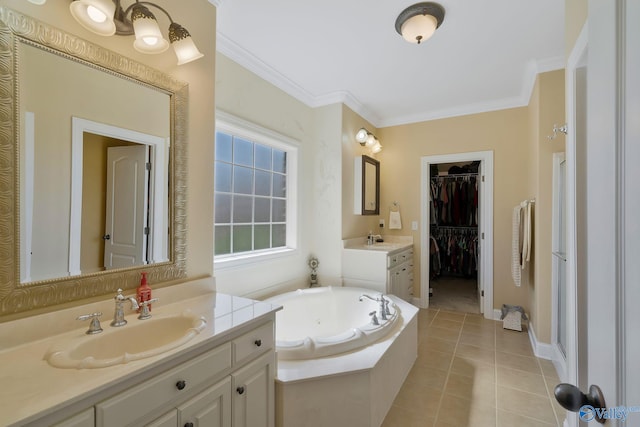 full bath with tile patterned floors, a jetted tub, ornamental molding, and a sink