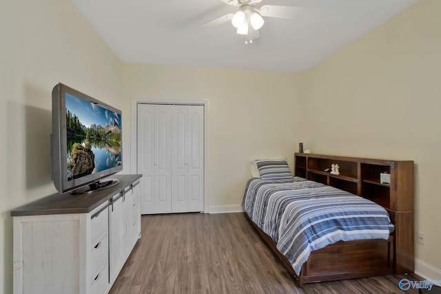 bedroom featuring a closet, ceiling fan, baseboards, and wood finished floors