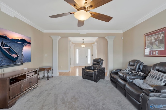 living area featuring decorative columns, light colored carpet, and ornamental molding