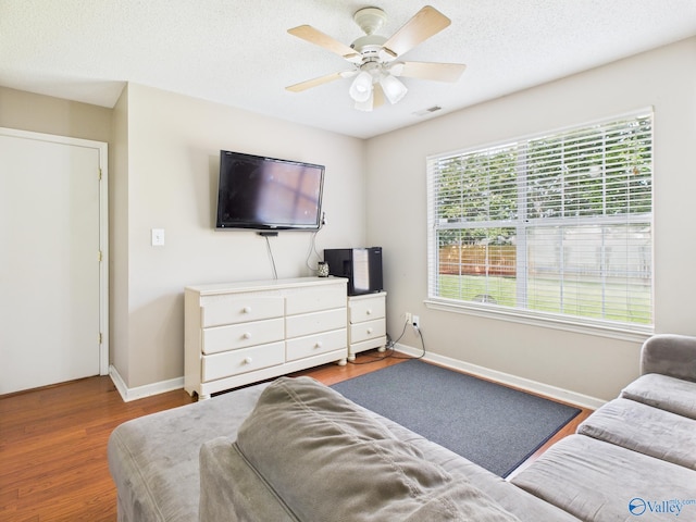201 Turnbrook Dr SW, Huntsville, AL 35824 - living area with wood finished floors, a ceiling fan, and a textured ceiling