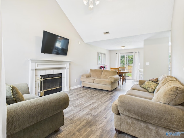 201 Turnbrook Dr SW, Huntsville, AL 35824 - living room featuring high vaulted ceiling, wood finished floors, and a tile fireplace