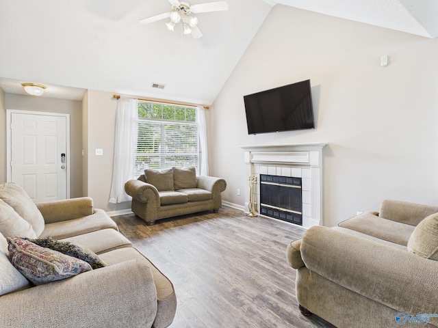 201 Turnbrook Dr SW, Huntsville, AL 35824 - living area with ceiling fan, a tile fireplace, wood finished floors, and high vaulted ceiling