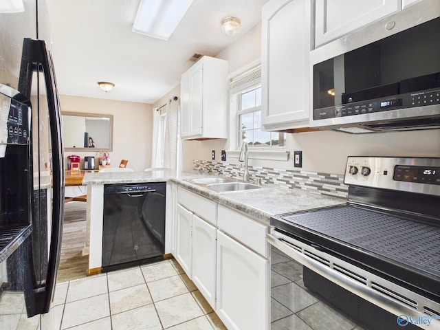 201 Turnbrook Dr SW, Huntsville, AL 35824 - kitchen with black appliances, white cabinetry, light countertops, and light tile patterned flooring