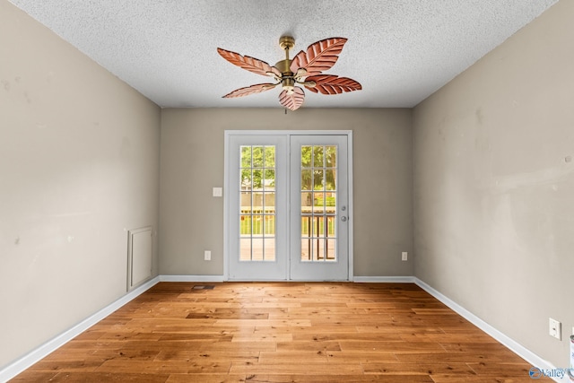 2009 SW Danbury Cir SW, Huntsville, AL 35803 - unfurnished room with light wood-type flooring, a textured ceiling, a ceiling fan, and baseboards