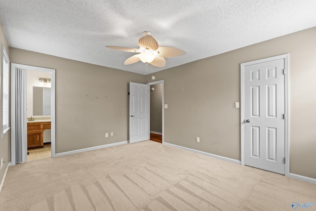 2009 SW Danbury Cir SW, Huntsville, AL 35803 - unfurnished bedroom featuring light colored carpet, a textured ceiling, ensuite bath, baseboards, and a ceiling fan