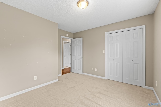 2009 SW Danbury Cir SW, Huntsville, AL 35803 - unfurnished bedroom with light carpet, baseboards, a closet, and a textured ceiling