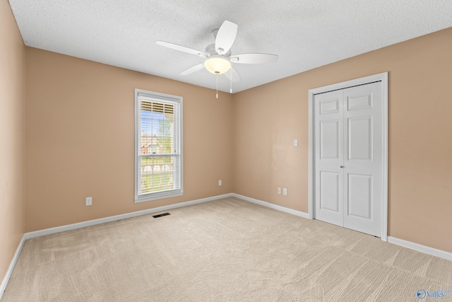 2009 SW Danbury Cir SW, Huntsville, AL 35803 - unfurnished bedroom with carpet flooring, a textured ceiling, baseboards, and a closet