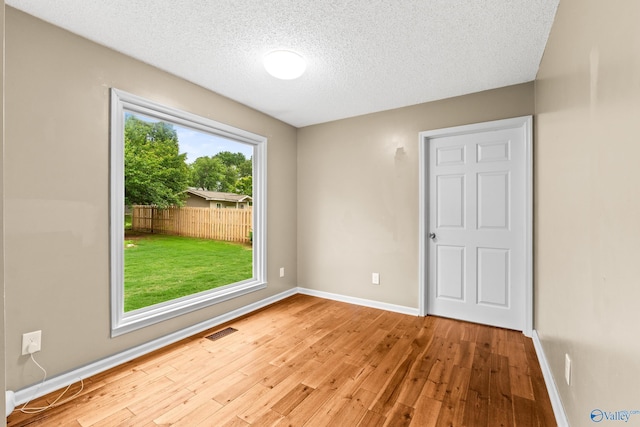 2009 SW Danbury Cir SW, Huntsville, AL 35803 - spare room featuring hardwood / wood-style floors, a textured ceiling, and baseboards