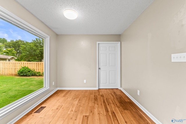 2009 SW Danbury Cir SW, Huntsville, AL 35803 - spare room featuring light wood-style floors, baseboards, and a textured ceiling