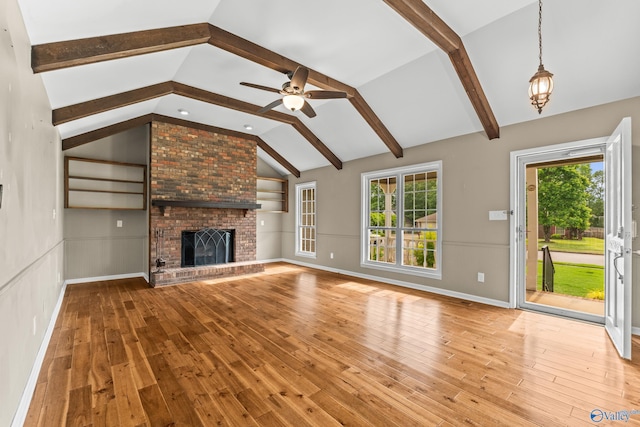 2009 SW Danbury Cir SW, Huntsville, AL 35803 - unfurnished living room with wood finished floors, healthy amount of natural light, a ceiling fan, and a fireplace