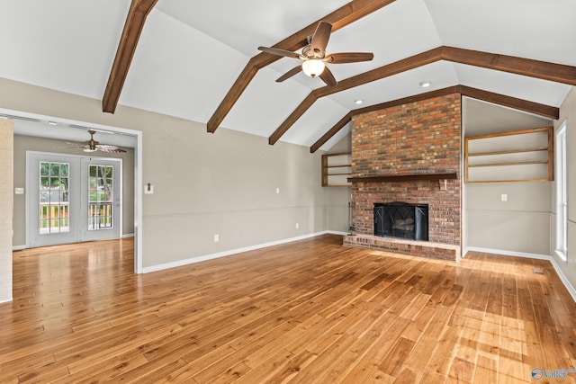 2009 SW Danbury Cir SW, Huntsville, AL 35803 - unfurnished living room featuring ceiling fan, hardwood / wood-style flooring, a brick fireplace, and baseboards