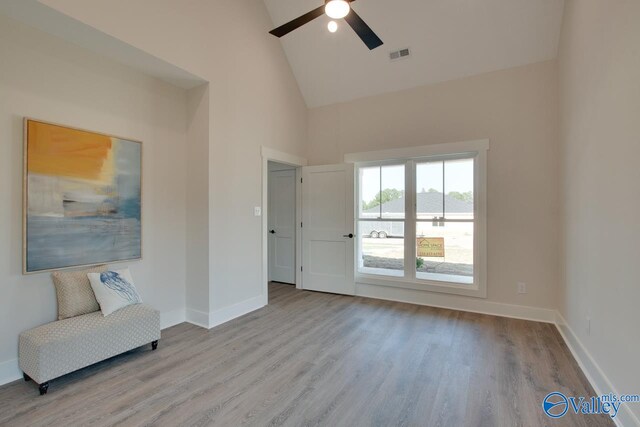 interior space featuring ceiling fan, light hardwood / wood-style flooring, and high vaulted ceiling