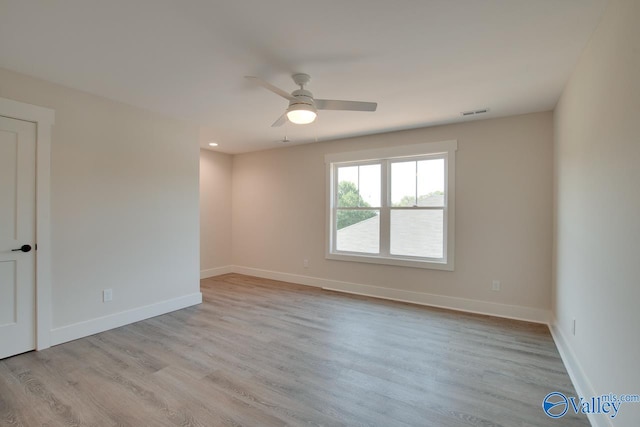 spare room featuring light wood-type flooring and ceiling fan