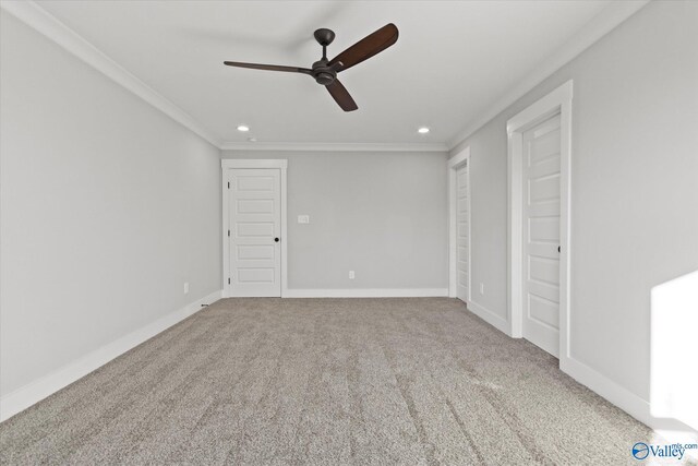 unfurnished bedroom featuring carpet floors, ornamental molding, and ceiling fan