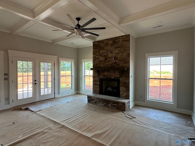 unfurnished living room with french doors, coffered ceiling, beamed ceiling, ceiling fan, and a fireplace