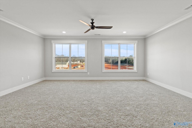 carpeted spare room featuring plenty of natural light, ornamental molding, and ceiling fan