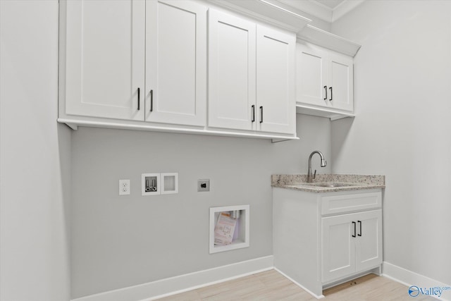 laundry area featuring sink, cabinets, hookup for a washing machine, electric dryer hookup, and light hardwood / wood-style flooring