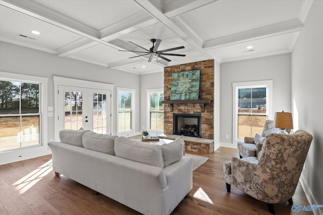 living room featuring coffered ceiling, hardwood / wood-style floors, and beamed ceiling