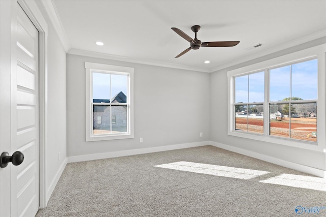 carpeted empty room featuring crown molding and ceiling fan