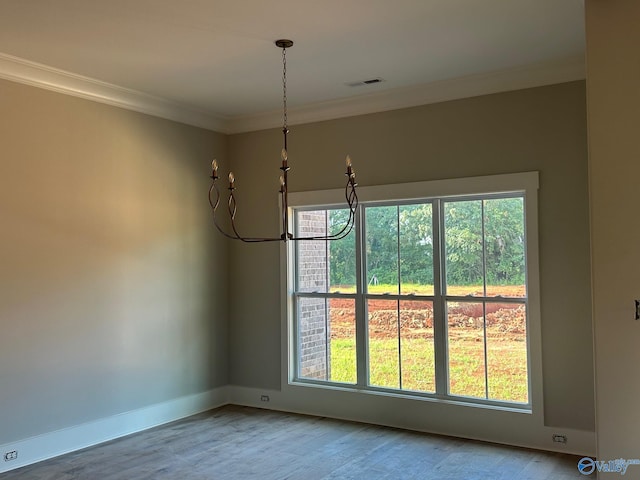 unfurnished dining area with wood-type flooring, ornamental molding, and a healthy amount of sunlight