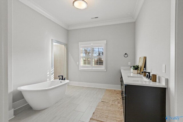 bathroom featuring ornamental molding, a tub, and vanity