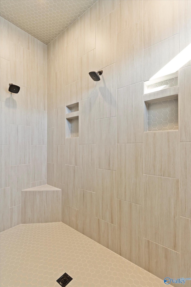 bathroom with a tile shower