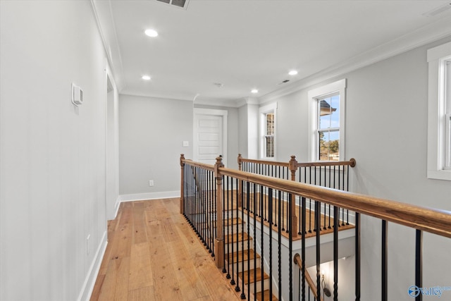 hallway featuring crown molding and light wood-type flooring