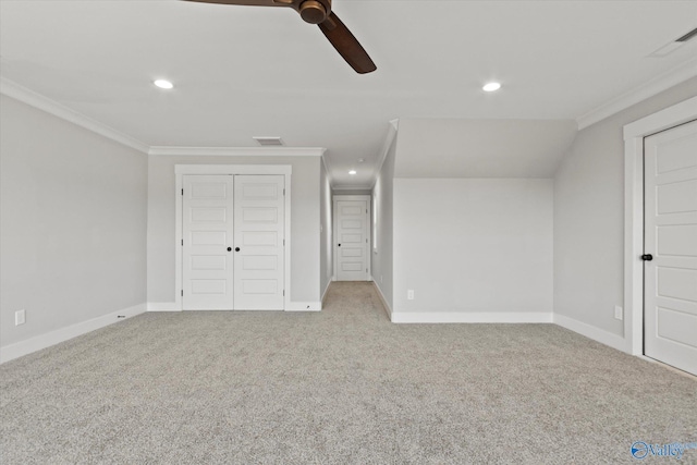unfurnished bedroom featuring ornamental molding, light colored carpet, a closet, and ceiling fan