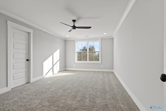 spare room featuring carpet floors, ornamental molding, and ceiling fan