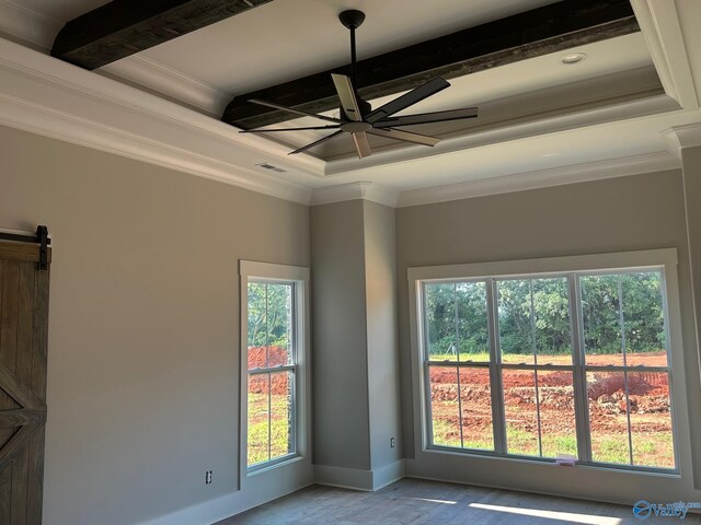 unfurnished room with ornamental molding, coffered ceiling, ceiling fan, a barn door, and beam ceiling
