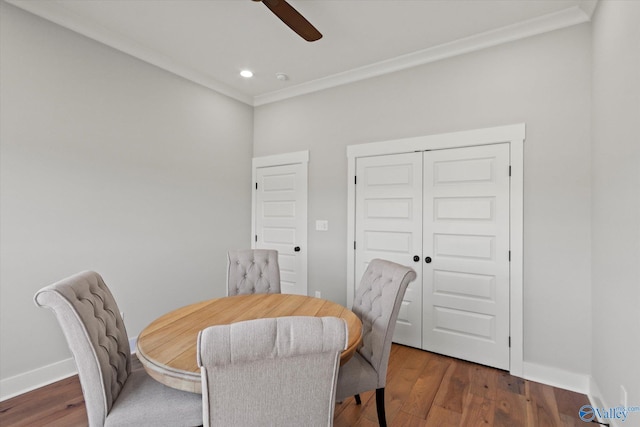 dining room with ornamental molding, dark wood-type flooring, and ceiling fan