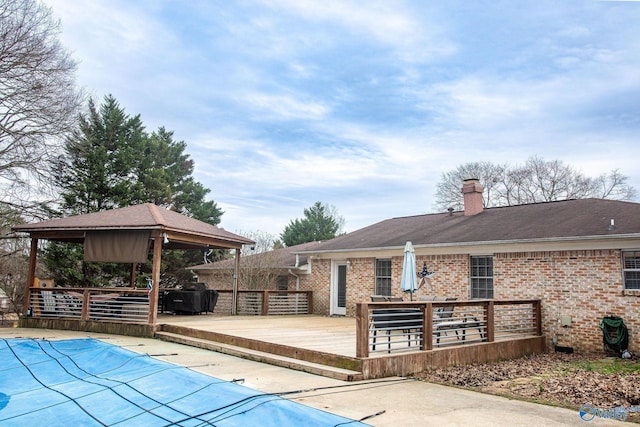 view of swimming pool featuring a gazebo and a deck