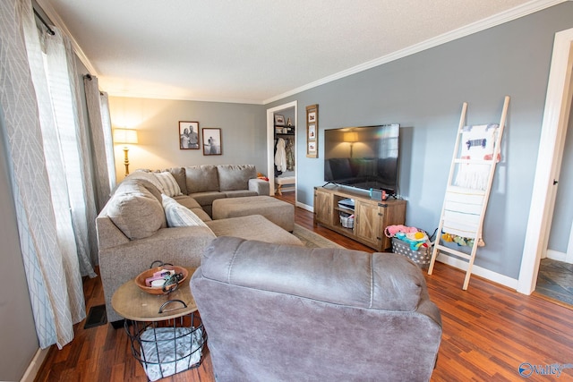 living room with crown molding and dark wood-type flooring