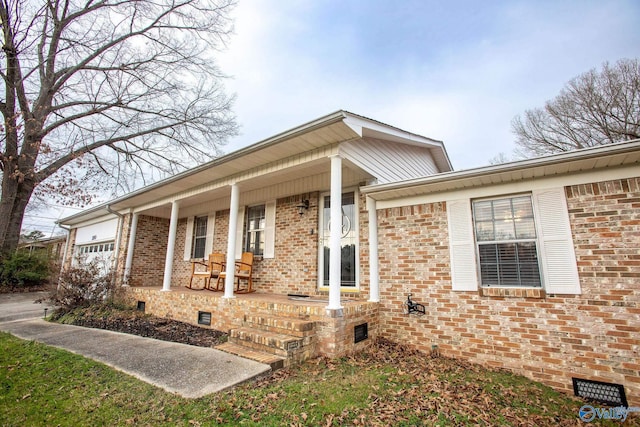 view of front of house with a porch and a garage