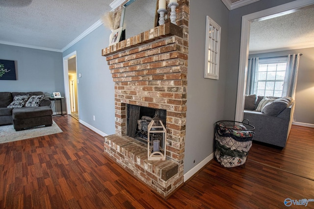 living room featuring a brick fireplace, ornamental molding, and a textured ceiling