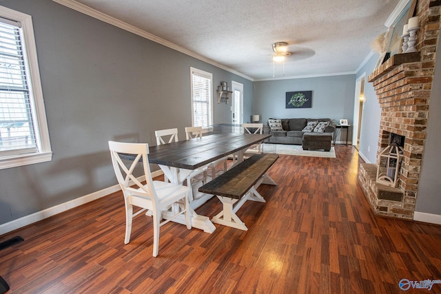 dining room featuring ornamental molding, dark hardwood / wood-style floors, and a textured ceiling