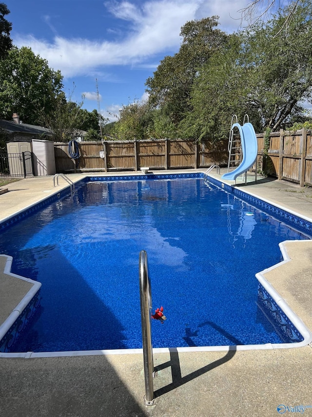 view of swimming pool featuring a water slide