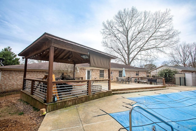 view of pool featuring a wooden deck and a gazebo