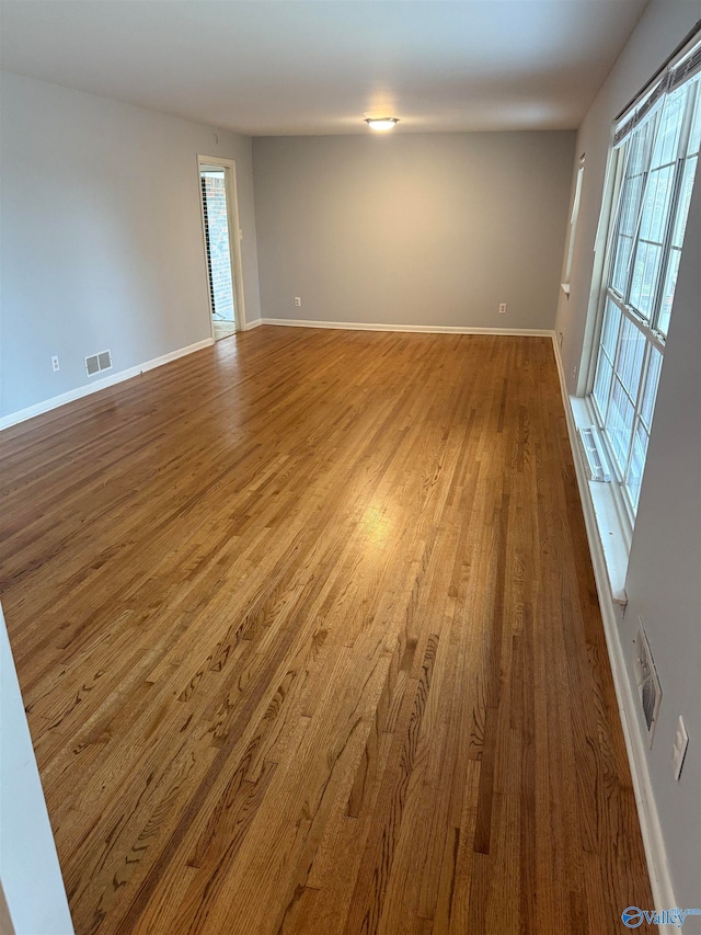 empty room with hardwood / wood-style floors