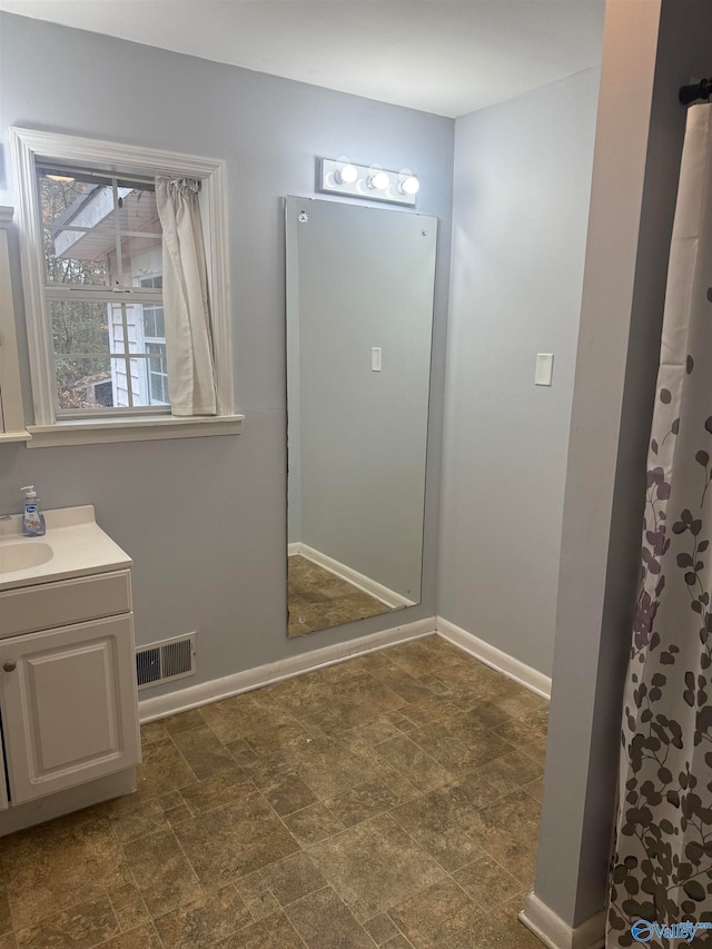 bathroom with vanity and a shower with shower curtain