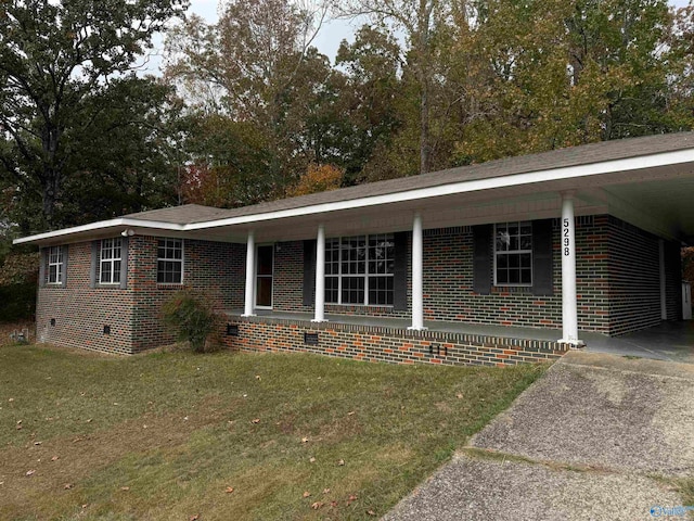 ranch-style home with a carport and a front lawn