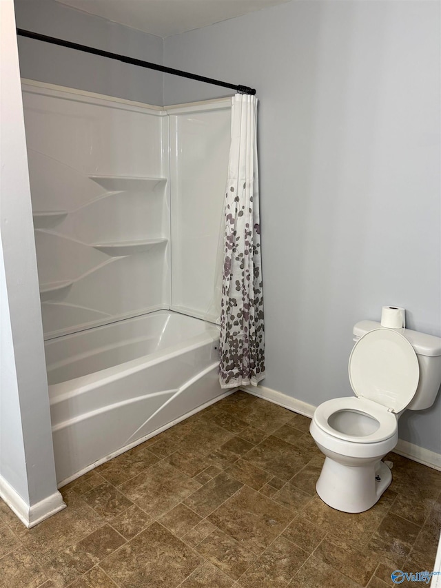 bathroom with shower / bath combo and toilet